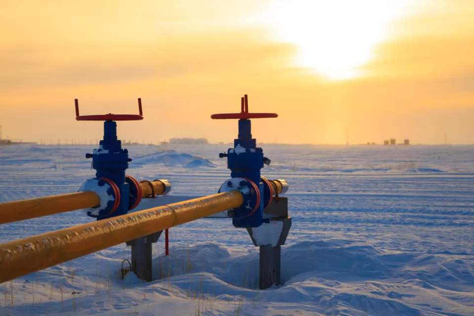 Two yellow pipes for natural gas or oil agains ta backdrop of snow